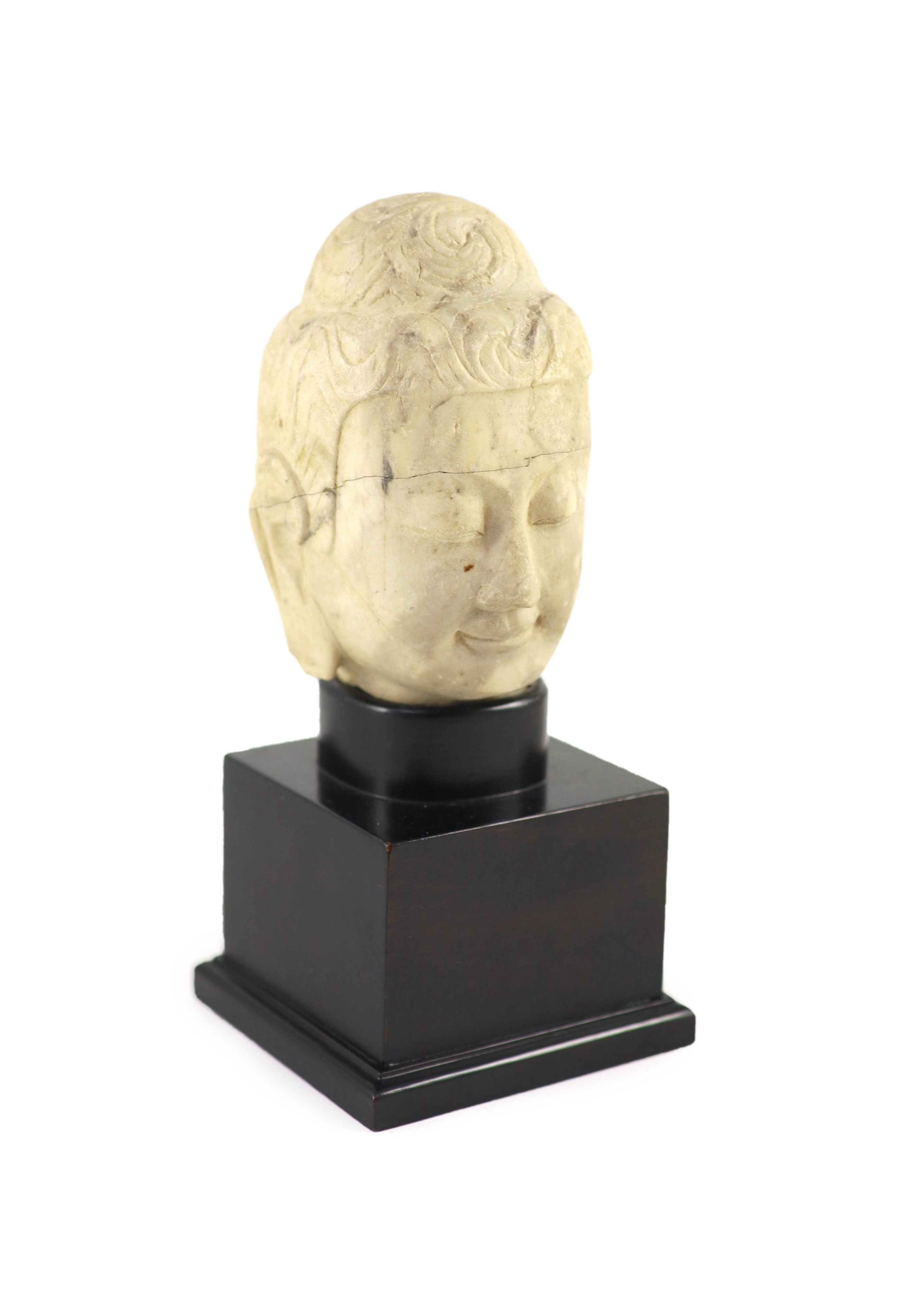 A Chinese carved white marble head of Buddha, Tang dynasty (618-907 AD), 16 cm high excluding later stand, old repairs